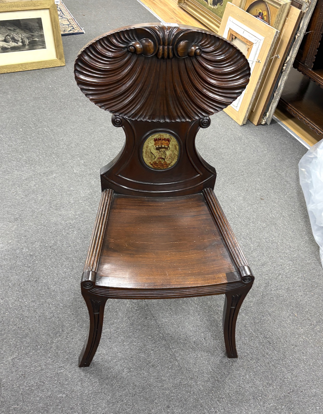 A George III style mahogany hall chair with painted armorial, width 39cm, depth 42cm, height 98cm